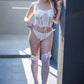 Elegant white lingerie corset with lace mesh details, styled for anniversaries or date nights.