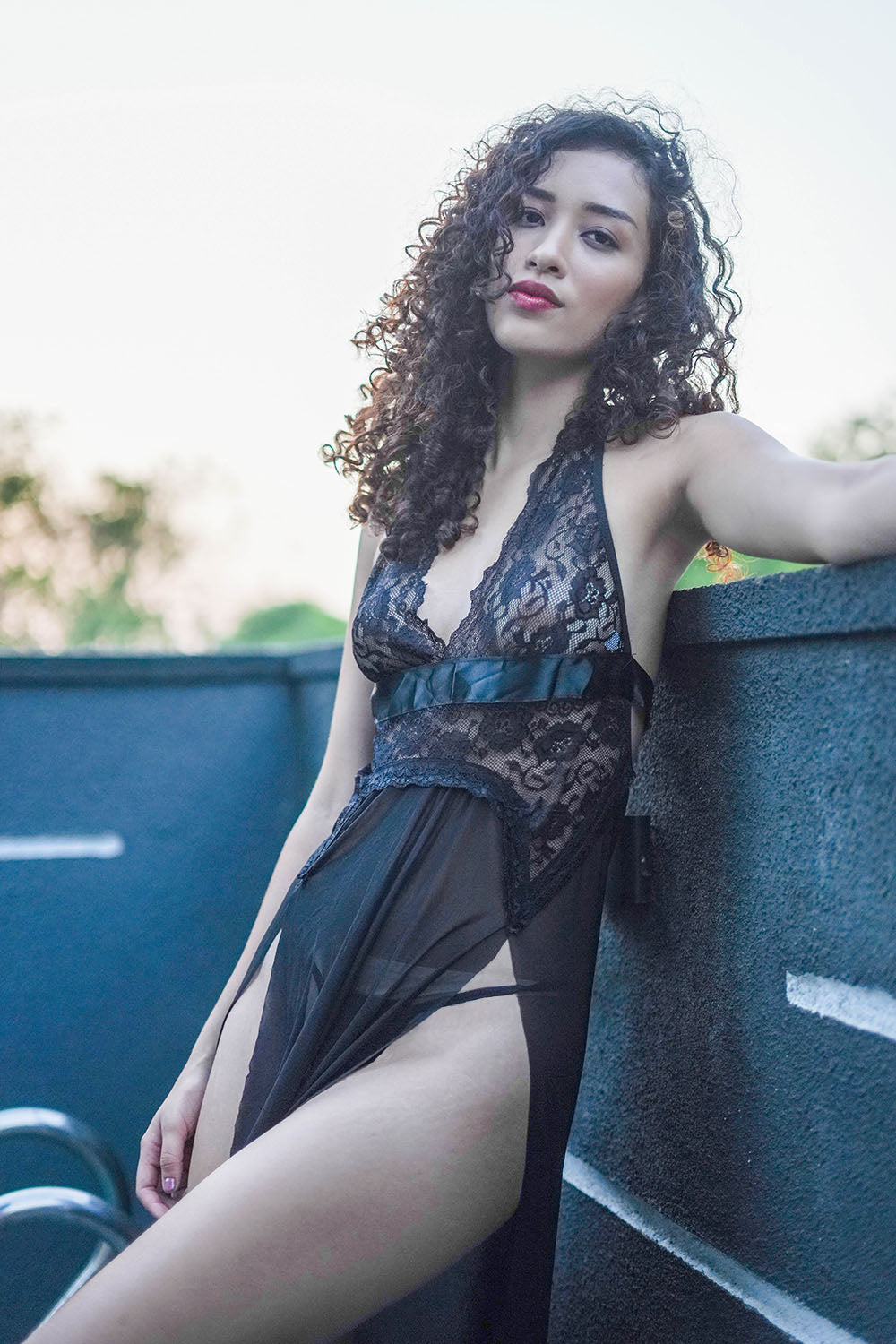 Outdoor shot of black lace babydoll dress, ideal for evening romance or special date nights.