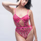 Pink lace teddy bodysuit with floral details, seductive lingerie for Valentine’s Day or romantic nightwear.