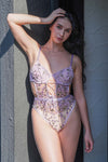Purple lace teddy bodysuit styled outdoors, sexy lingerie for special date nights and intimate moments.