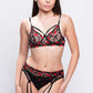 Sheer black lingerie set with red floral embroidery and garter straps, perfect for romantic nights or bridal trousseau.