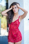 Red lace babydoll lingerie with heart accents, styled for honeymoon or anniversary night.