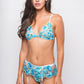 Model wearing a floral embroidered blue lingerie set with bra, garter belt, and matching thong, designed for a sensual and elegant look.