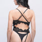 Back view of black lace teddy bodysuit featuring crisscross straps and cutout lace panel.