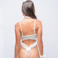 Back view of white lace bunny bodysuit with strappy detail and fluffy tail, perfect for intimate roleplay or costume night.