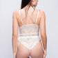 Back view of white lace teddy bodysuit with thong fit, elegant and sexy bridal nightwear.