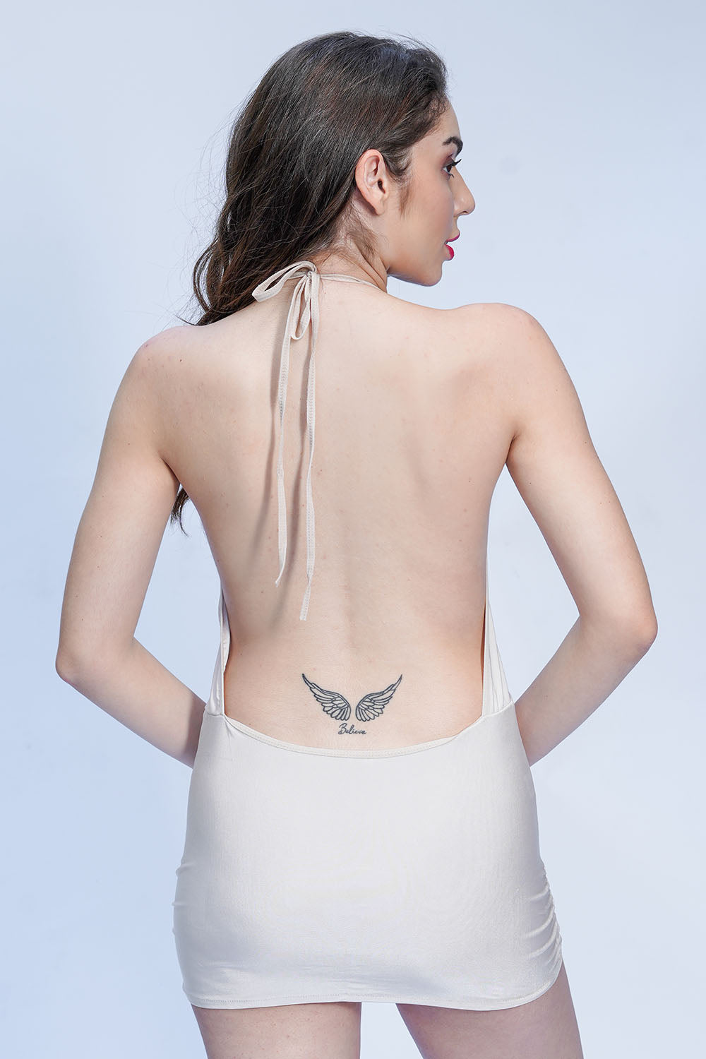Backless cream babydoll nightwear with tie-up detail, sensual bedroom lingerie style.