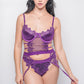 A woman models a purple lingerie set with garter straps and thigh-high stockings. Perfect for intimate events, bedroom wear, and romantic occasions.