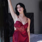Model leaning at doorway in red satin and lace babydoll dress, ideal for honeymoon and special nightwear.