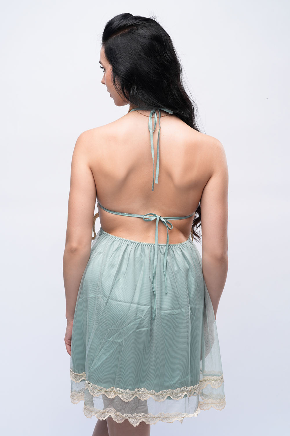 Back view of green sheer babydoll lingerie with halter-neck tie, designed for special occasions.