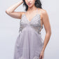 Woman posing in sheer light purple lace babydoll nightwear, perfect for romantic evenings or honeymoon nights.