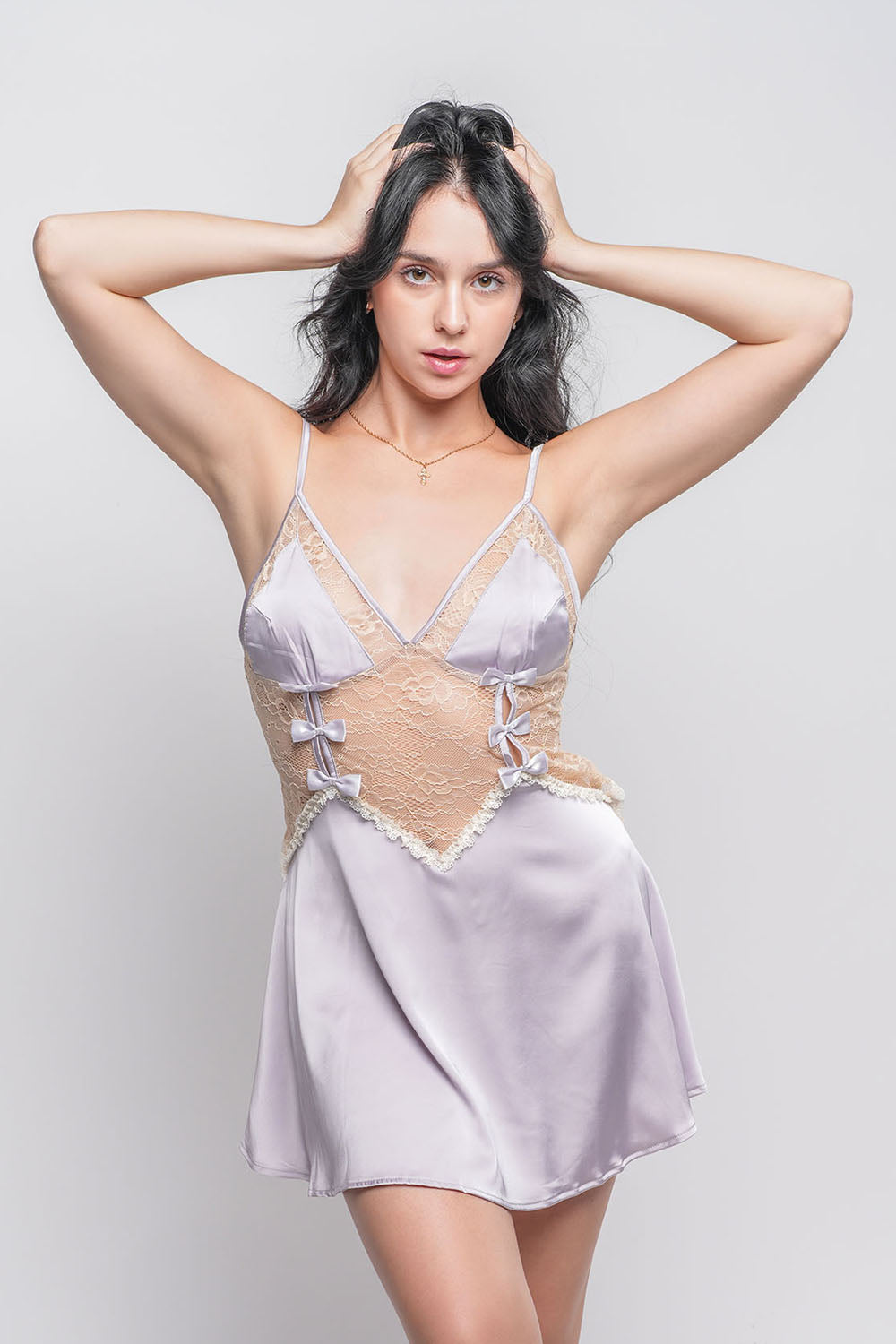 Purple satin babydoll dress with lace bodice and bow accents, intimate nightwear.