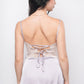 Back view of lavender satin babydoll dress with lace-up ribbon detail and lace hem.