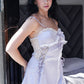 Woman standing indoors in lavender satin lace-trim babydoll dress, side-front view.