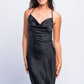 Woman wearing black satin babydoll dress with cowl neckline, elegant nightwear for evening wear.
