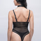 Rear view of black strappy teddy bodysuit with thong back, daring bedroom wear for couples.