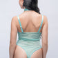 Back view of cyan teddy bodysuit with cheeky thong cut, bold intimate wear for special nights.