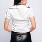Back view of white police uniform costume showing cropped shirt and leather skirt – seductive cosplay lingerie.